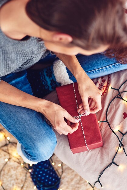 Młoda kobieta pakowania prezent świąteczny