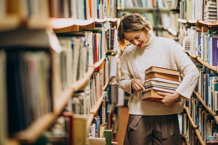 Bezpłatny plik Zdjęcie młoda kobieta studiuje w bibliotece