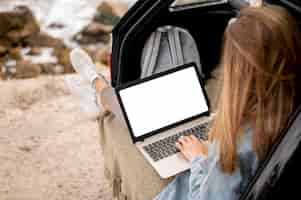 Bezpłatne zdjęcie młoda kobieta wyszukuje laptopa na wycieczkę