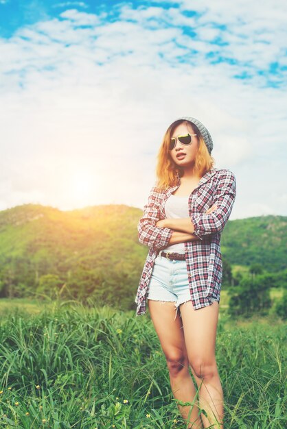 Młoda piękna kobieta, stojąca hipster skrzyżowane ramiona pośród natur