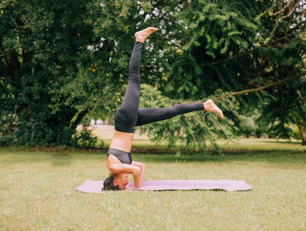 Bezpłatne zdjęcie młoda sporty atrakcyjna kobieta ćwiczy joga; wykonywanie ćwiczeń headstand