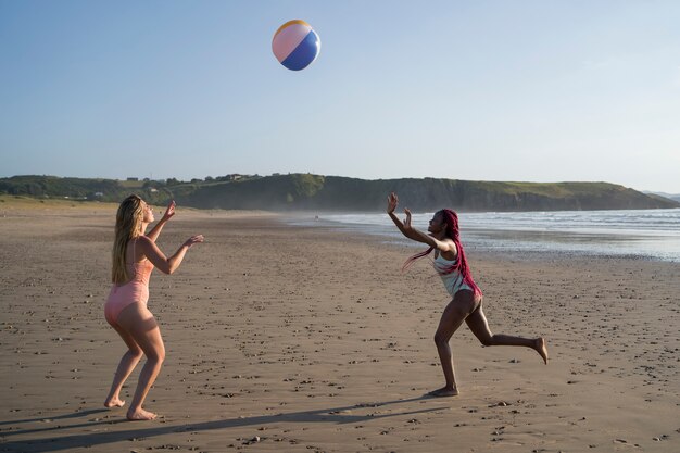Młode kobiety bawią się na plaży