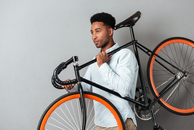 Młody afro amerykański mężczyzna przewożenie bicykl
