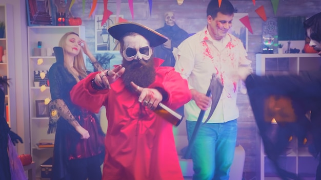 Młody brodaty mężczyzna przebrany za pirata zabawy na imprezie z okazji halloween.