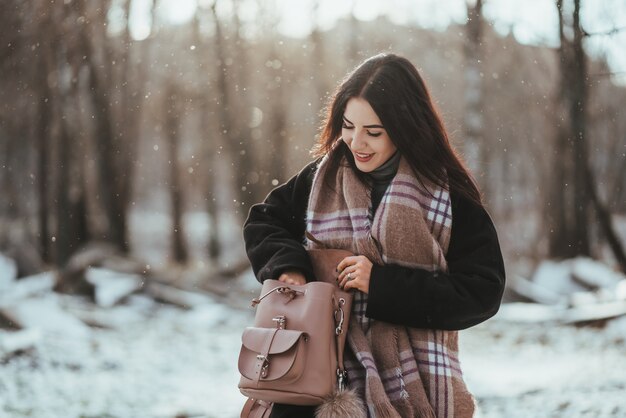 Młody piękny model pozuje w zima lesie