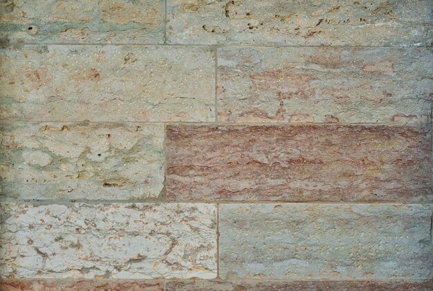 Naturalne tło ściany z piaskowca lub tekstura do tapety Mur ścienny na elewację domu lub projekt budynku i przestrzeń wewnętrzną