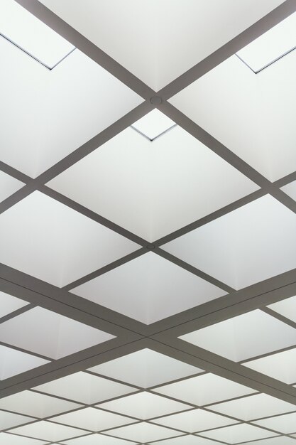 Niskie ujęcie sufitu budynku wykonanego z jasno oświetlonych kwadratów