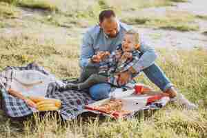 Bezpłatne zdjęcie ojcuje z synem ma pinkin w parku