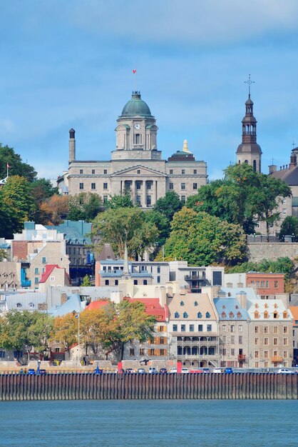 Panoramę miasta Quebec nad rzeką z niebieskim niebem i chmurą.