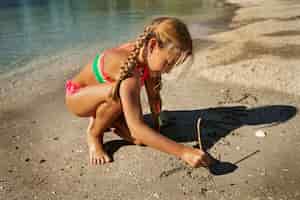 Bezpłatne zdjęcie pełna dziewczyna gra na plaży?