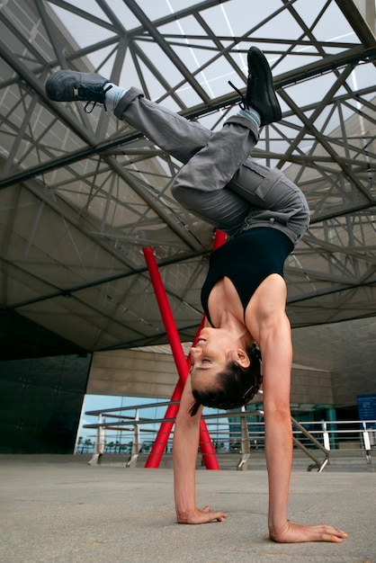 Bezpłatne zdjęcie pełna dziewczyna robi trening parkour