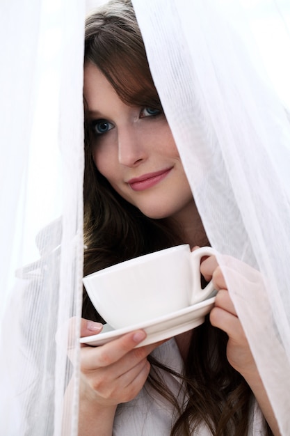 Piękna kobieta z filiżanką gorącej kawy
