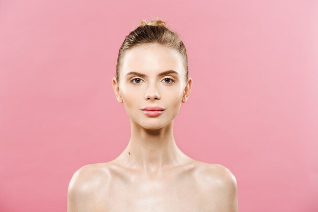 Piękna koncepcja - piękna kobieta z Czystym Świeżymi skórkami bliska na różowe studio. Twarz do pielęgnacji skóry. Kosmetyka.