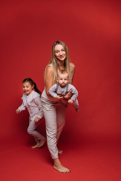 Piękna mama raduje się swoimi pięknymi dziećmi i uśmiechem