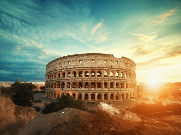 Piękny strzał słynnego rzymskiego amfiteatru w Koloseum pod zapierającym dech w piersiach niebem o wschodzie słońca