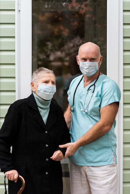 Pielęgniarka i starsza kobieta z maskami medycznymi