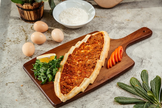 płaski chleb turecki z mielonym mięsem i polewą pomidorową