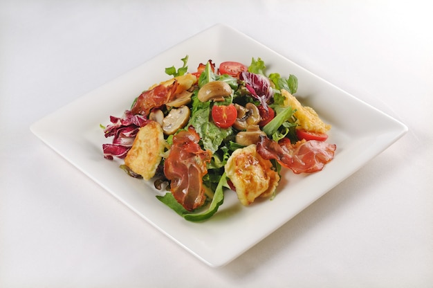 Pojedyncze ujęcie talerza z sałatką z kurczakiem i boczkiem - idealne do wykorzystania na blogu kulinarnym lub w menu