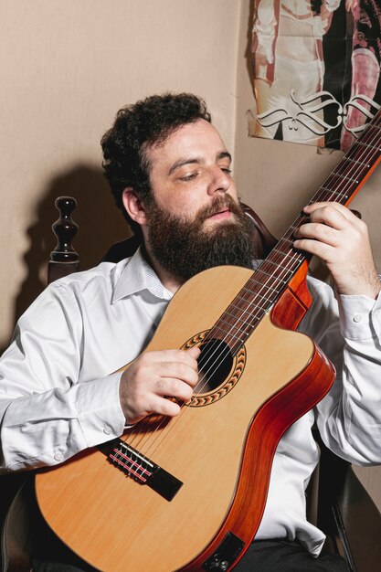 Portret mężczyzna gra na gitarze akustycznej