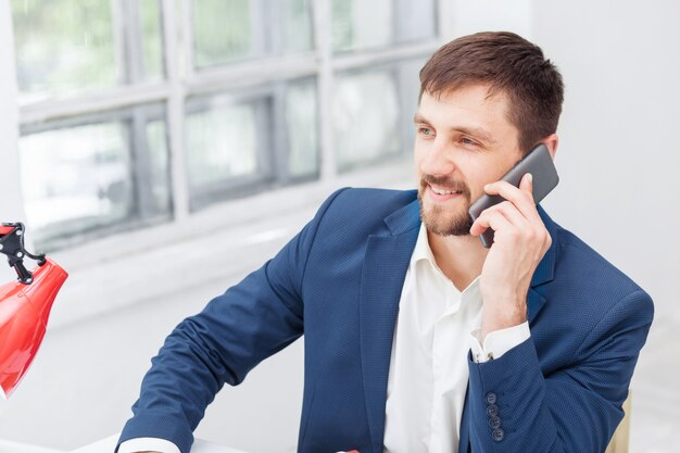 Portret opowiada na telefonie w biurze biznesmen
