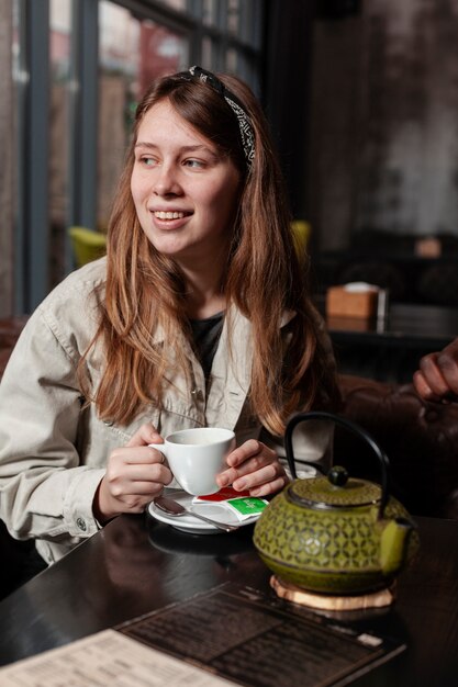 Portret piękna kobiety mienia herbata