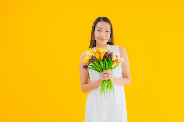 Portret piękna młoda azjatykcia kobieta z kwiatem