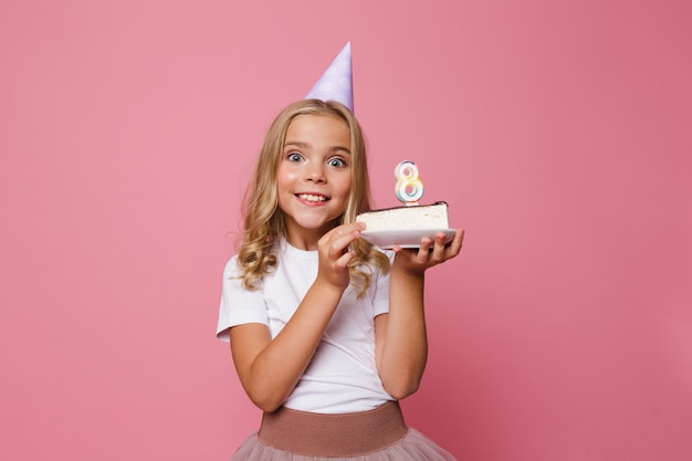Portret rozochocona mała dziewczynka w urodzinowym kapeluszu