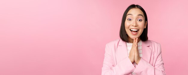 Portret szczęśliwej azjatyckiej biurowej pani dyrektor generalnej bizneswoman w garniturze, radującej się i śmiejącej się wygrywając celebra