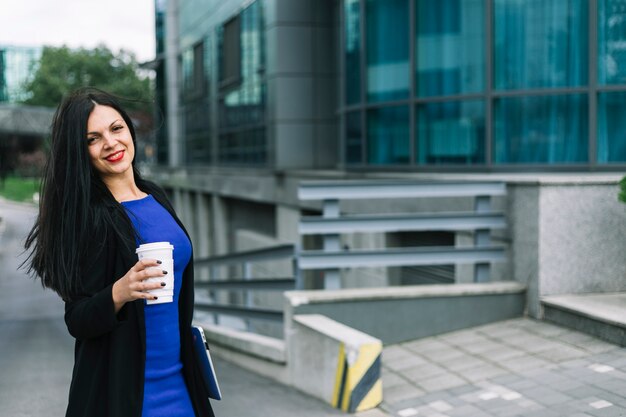 Bezpłatne zdjęcie portret szczęśliwy bizneswoman z usuwanie filiżanką