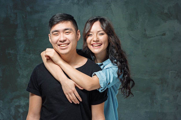 Portret uśmiechnięta koreańska para na szarym tle studio