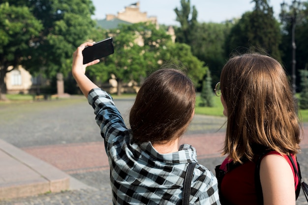 Powrót widok średni strzał nastoletnich dziewcząt przy selfie