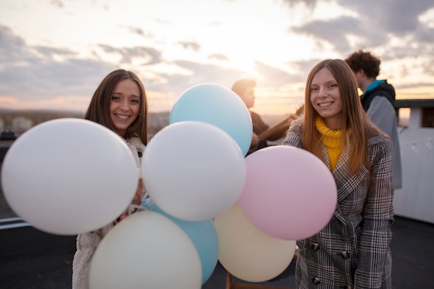 Przyjaciele ze średnim strzałem z balonami