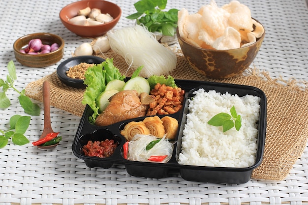 Pudełko ryżowe lub indonezyjski nasi kotak z sosem sojowym kurczak oreg tempeh i pikantną pastą