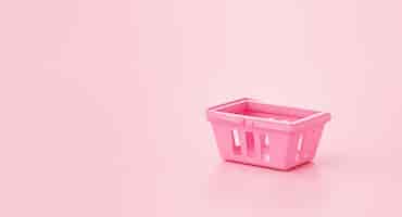 Bezpłatne zdjęcie pusty koszyk na zakupy koncepcja zakupów online na różowym tle renderowania 3d