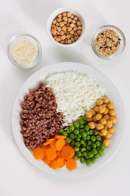 Różne rodzaje owsianki z warzywami na talerzu z miseczkami ryżu