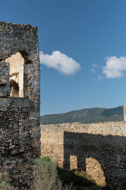Ruiny opuszczonego greckiego miasta Levissi w pobliżu wioski Kayakoy w Fethiye Turcja na tle cumulusów tragedia wojen Miejsce starożytnego miasta Karmilissos