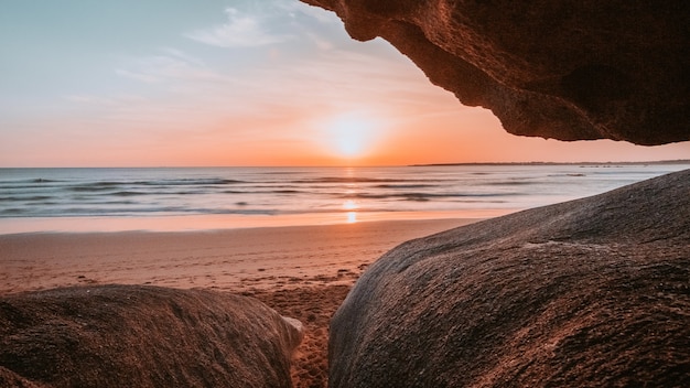 Bezpłatne zdjęcie słońce widziane przez klify plaży