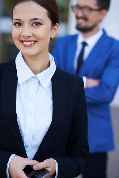 Smiling businesswoman z jej telefonu komórkowego