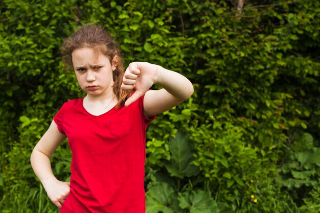 Smutny mała dziewczynka seansu niechęci gest w parku