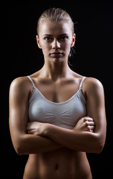 Sportowy brzuch kobiety stojącej na białym tle na ciemnym tle