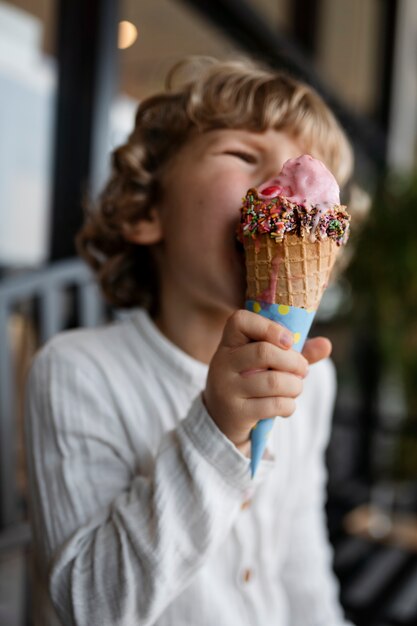 Średni strzał dziecko liżące lody w rożku