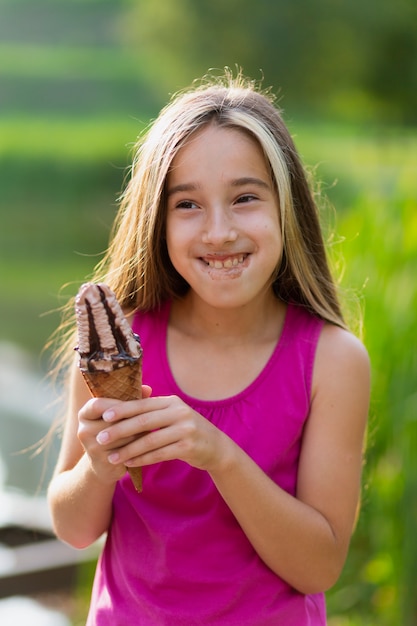 Średni strzał dziewczyny jeść lody