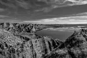 Bezpłatne zdjęcie strzał w skali szarości gór w pobliżu jeziora w burujon, hiszpania