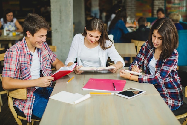 Bezpłatne zdjęcie studenci w kawiarni czytania materiałów