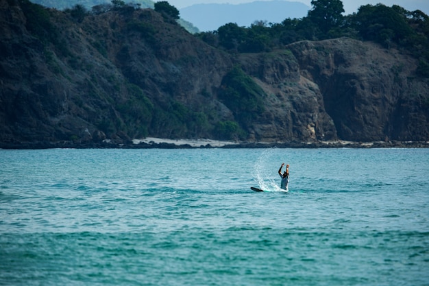 Surfer na błękitnej fali.