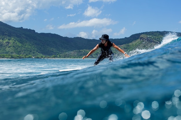 Surfer na błękitnej fali.