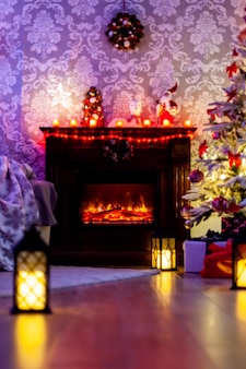 Świąteczny salon z kominkiem, świąteczne oświetlenie. błyszczące ozdoby choinkowe.