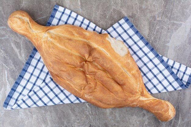 Bezpłatne zdjęcie Świeży, pyszny chleb leżący na obrusie. zdjęcie wysokiej jakości