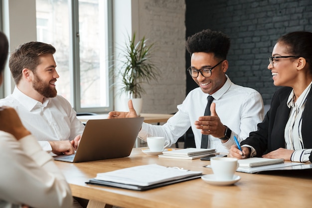 Bezpłatne zdjęcie szczęśliwi młodzi koledzy indoors coworking