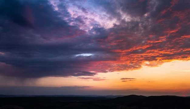 Szeroki kąt strzału kilku chmur na niebie podczas zachodu słońca malowane w wielu kolorach
